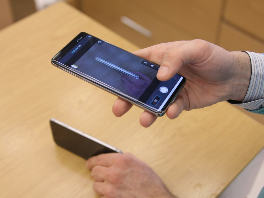 Designer testing a mobile app prototype on a smartphone